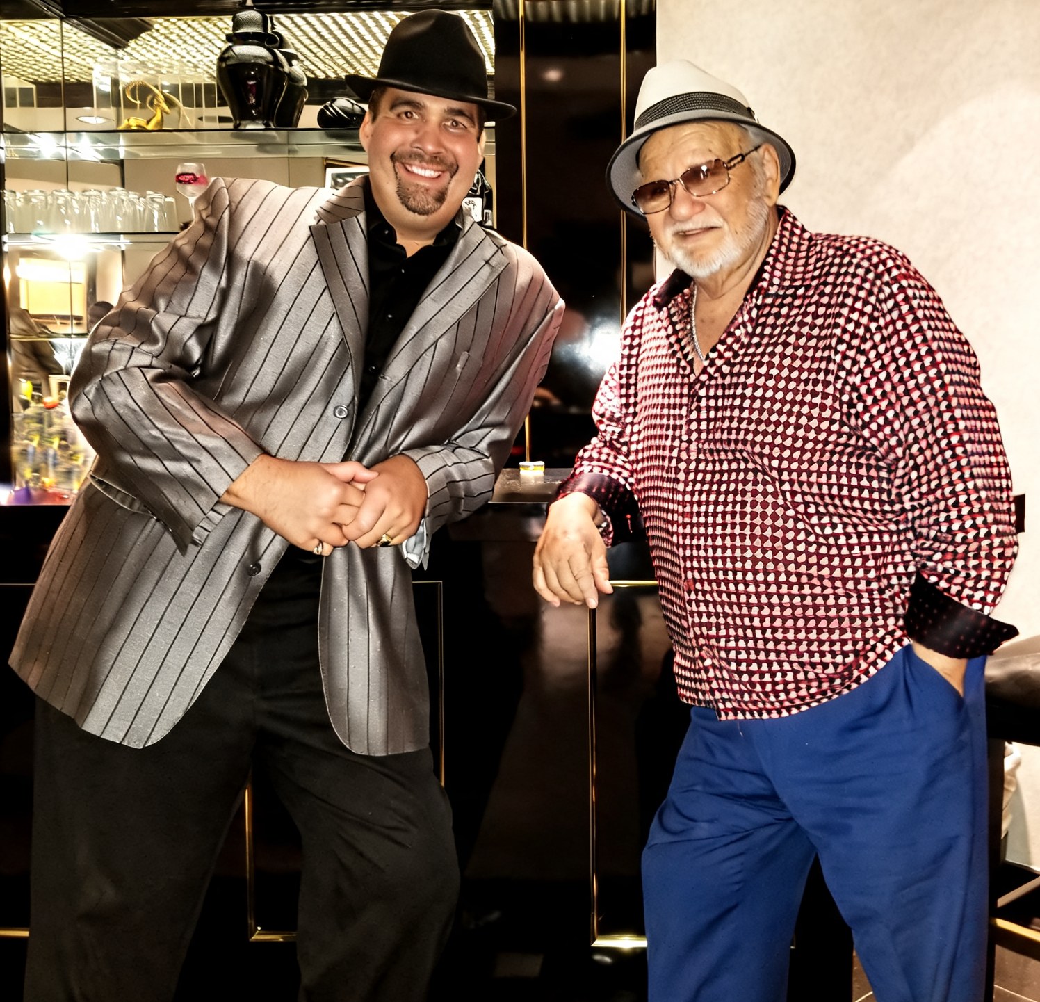 Adam Flowers in a silver jacket and black hat with Frank Cullotta in a white hat, red shirt, and blue pants